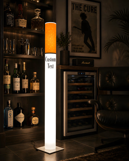 Giant cigarette lamp in a dark luxury home bar with a backlit whiskey bottle cabinet and built in wine fridge
