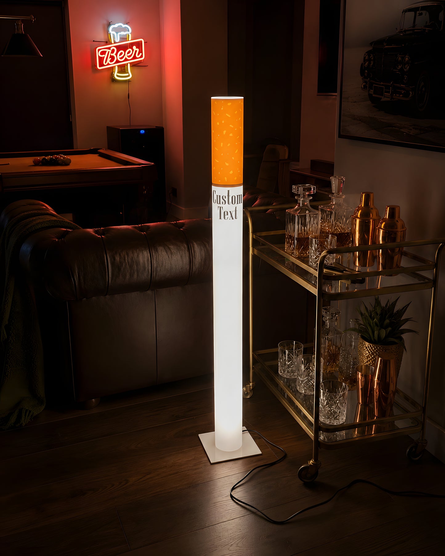 Vintage giant cigarette floor lamp 95 cm glowing in a man cave game room beside a leather sofa, gold bar cart and neon beer sign