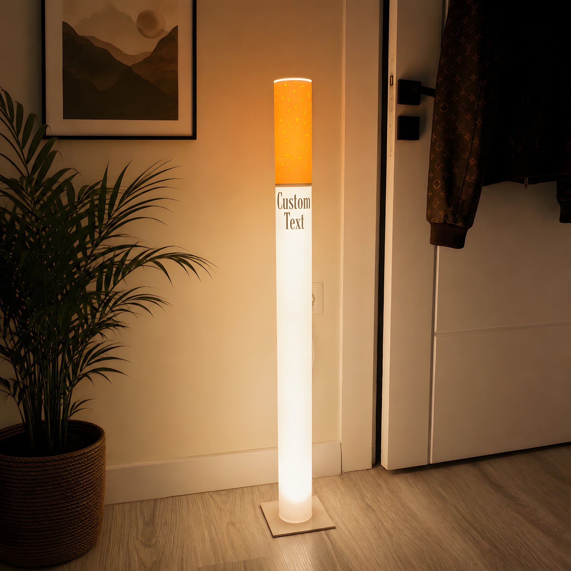 Vintage cigarette floor lamp used as a statement light in a minimal entryway hallway with a palm plant and framed art