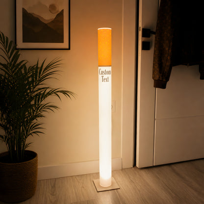 Vintage cigarette floor lamp used as a statement light in a minimal entryway hallway with a palm plant and framed art