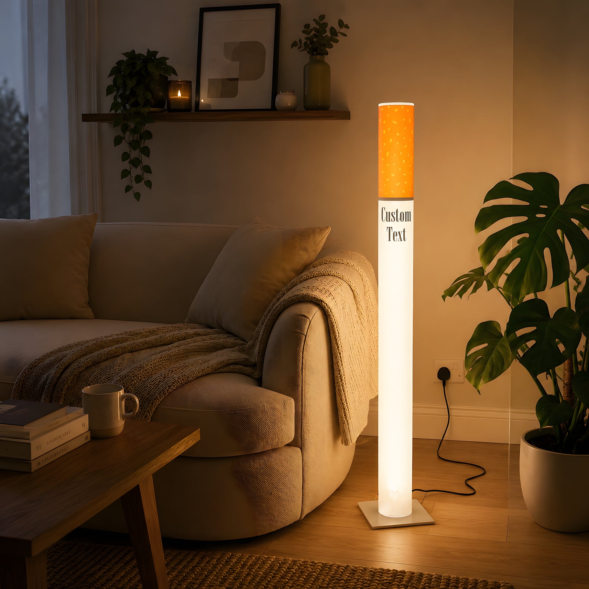 Giant cigarette lamp 95 cm as ambient lighting in a bright modern living room with a cream curved sofa and monstera plant
